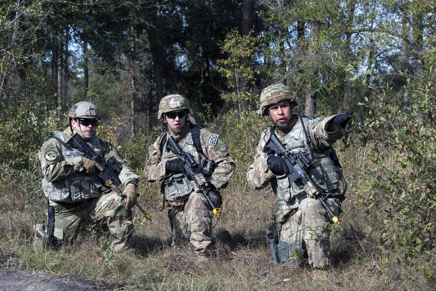 Staff Sgt. Lloyd Lowery, 824th Base Defense Squadron fire team member, far right, directs his counterparts Senior Airman Tyler Evans, middle, and Tech. Sgt. Timothy Gallagher, during dismount training, Dec. 8, 2016, at Moody Air Force Base, Ga. The team was evaluated on their ability to locate weapons and their communication skills after the scenario. (U.S. Air Force photo by Airman 1st Class Greg Nash)