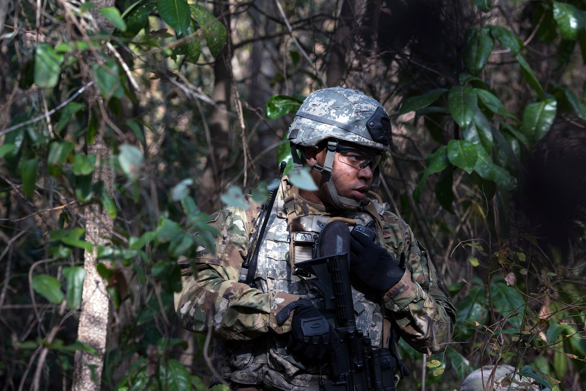 Staff Sgt. Justin Harris, 824th Base Defense Squadron fire team member, radios in his location while searching for mock insurgents during dismount training, Dec. 8, 2016, at Moody Air Force Base, Ga. The 824th BDS gathered intelligence on their adversaries’ movements, improvised explosive devices and weaponry during the training. (U.S. Air Force photo by Airman 1st Class Greg Nash)