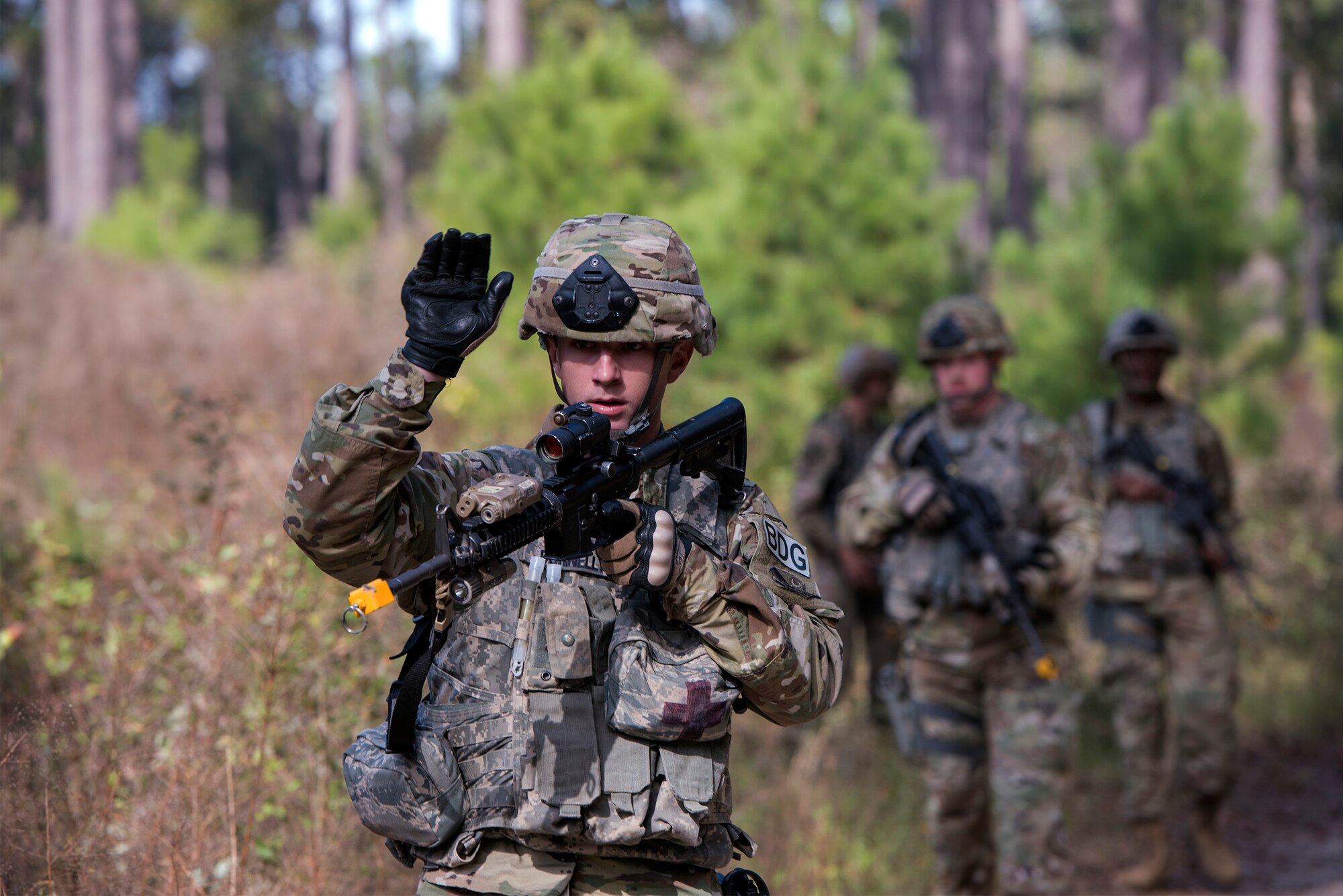 Airman Cole Donnelly, 824th Base Defense Squadron fire team member, motions his squad team forward during dismount training, Dec. 8, 2016, at Moody Air Force Base, Ga. The 824th BDS is part of the 820th Base Defense Group, which provides the expeditionary Air Force's only worldwide deployable, first-in, fully integrated, multi-disciplined, highly qualified, self-sustaining force protection capability. (U.S. Air Force photo by Airman 1st Class Greg Nash)