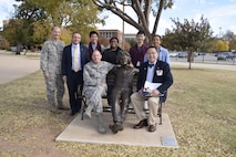 Air Force Sustainment Center Commander Lt. Gen. Lee K. Levy II, seated left, is joined by Oklahoma School of Science and Mathematics President Dr. Frank Y.H. Wang, seated right, as they pose with a statue of Dr. Albert Einstein toward the end of a visit by AFSC senior leaders Dec. 1. Shown standing are, from left, Col. Charles Gaona, AFSC Engineering deputy director; Kevin Stamey, AFSC Engineering director; and OSSM students Jimmy Ma, Sahar Hasan, Aaron Park and Lawton Blanchard. (U.S. Air Force photo/Greg L. Davis)