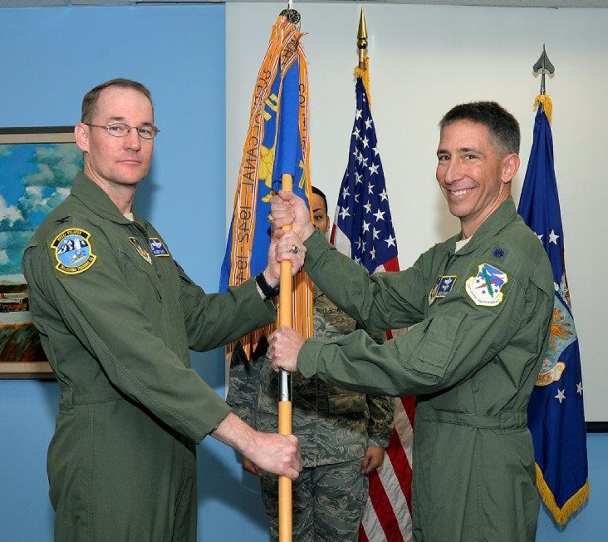 Lt. Col. Jason Cashman (right) accepts the 70 FTS guidon from Col. Roger Suro, Commander of the 340th Flying Training Group, Joint Base San Antonio-Randolph-Texas during the Change of Command Ceremony Dec. 1 at the U.S. Air Force Academy. These ceremonies represent the formal passing of responsibility, authority and accountability of command from one officer to another. (U.S. Air Force photo).