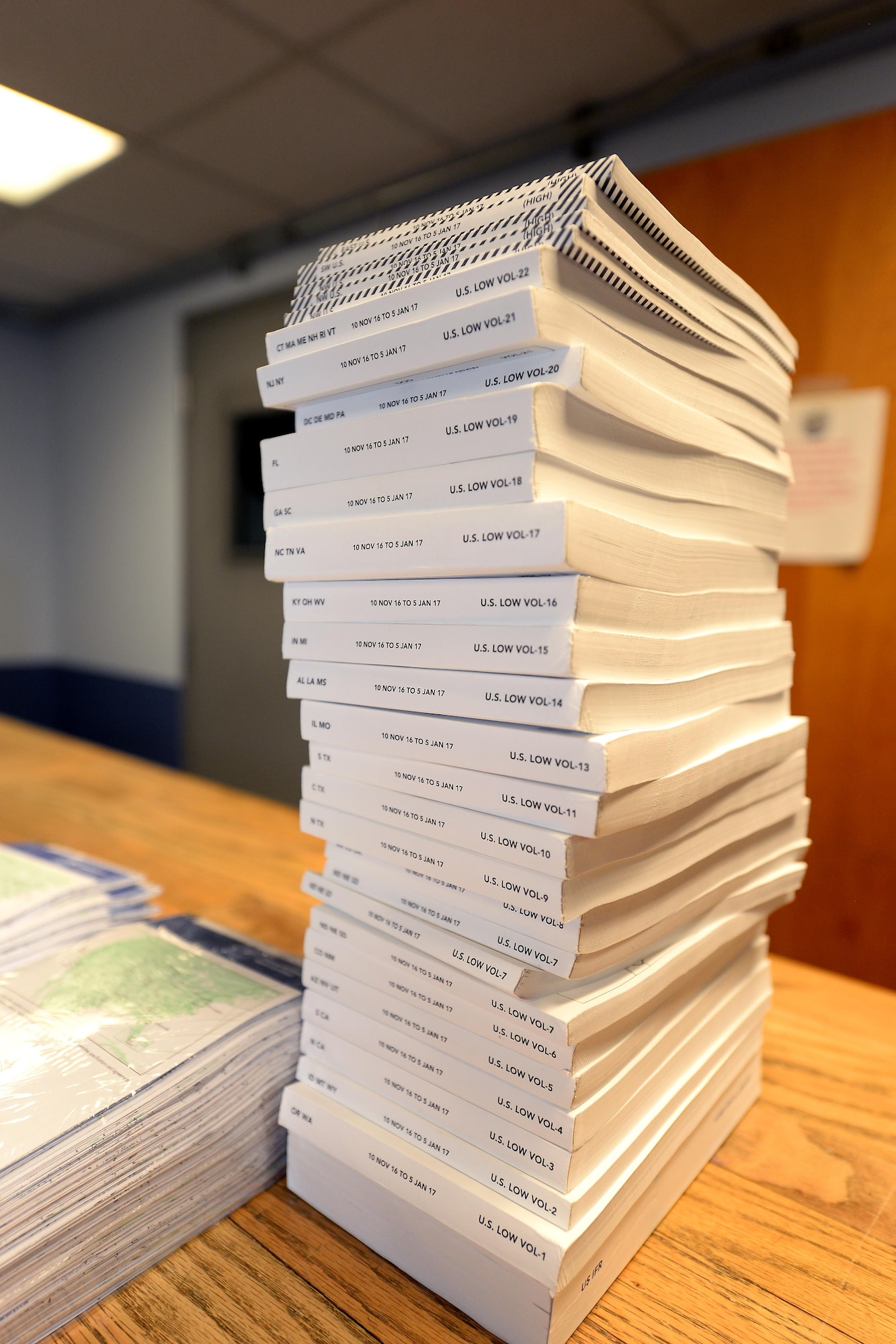 A stack of flight information publications sits on a counter as combat crew communications personnel build FLIP bags for Offutt missions Nov. 30, 2016 at Offutt Air Force Base, Neb. (U.S. Air Force photo by Delanie Stafford)