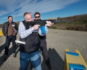 Chris Dage shoots simulated rounds from an M-16 during the honorary commanders tour of the 60th Mission Support Group, Dec. 2, 2016. The purpose of the Travis Honorary Commander Program is to promote relationships between base senior leadership and civilian partners, foster civic appreciation of the Air Force mission and its Airmen, maximize opportunities to share the Air Force story with new stewards, and communicate mutual interest, challenges, and concerns that senior leaders and civilian stakeholders have in common. (U.S. Air Force photo/Louis Briscese)