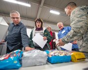 Honorary commanders from Travis Air Force Base, Calif., go through a mock deployment processing line during their tour of the 60th Mission Support Group, Dec. 2, 2016. The purpose of the Travis Honorary Commander Program is to promote relationships between base senior leadership and civilian partners, foster civic appreciation of the Air Force mission and its Airmen, maximize opportunities to share the Air Force story with new stewards, and communicate mutual interest, challenges, and concerns that senior leaders and civilian stakeholders have in common. (U.S. Air Force photo/Louis Briscese)
