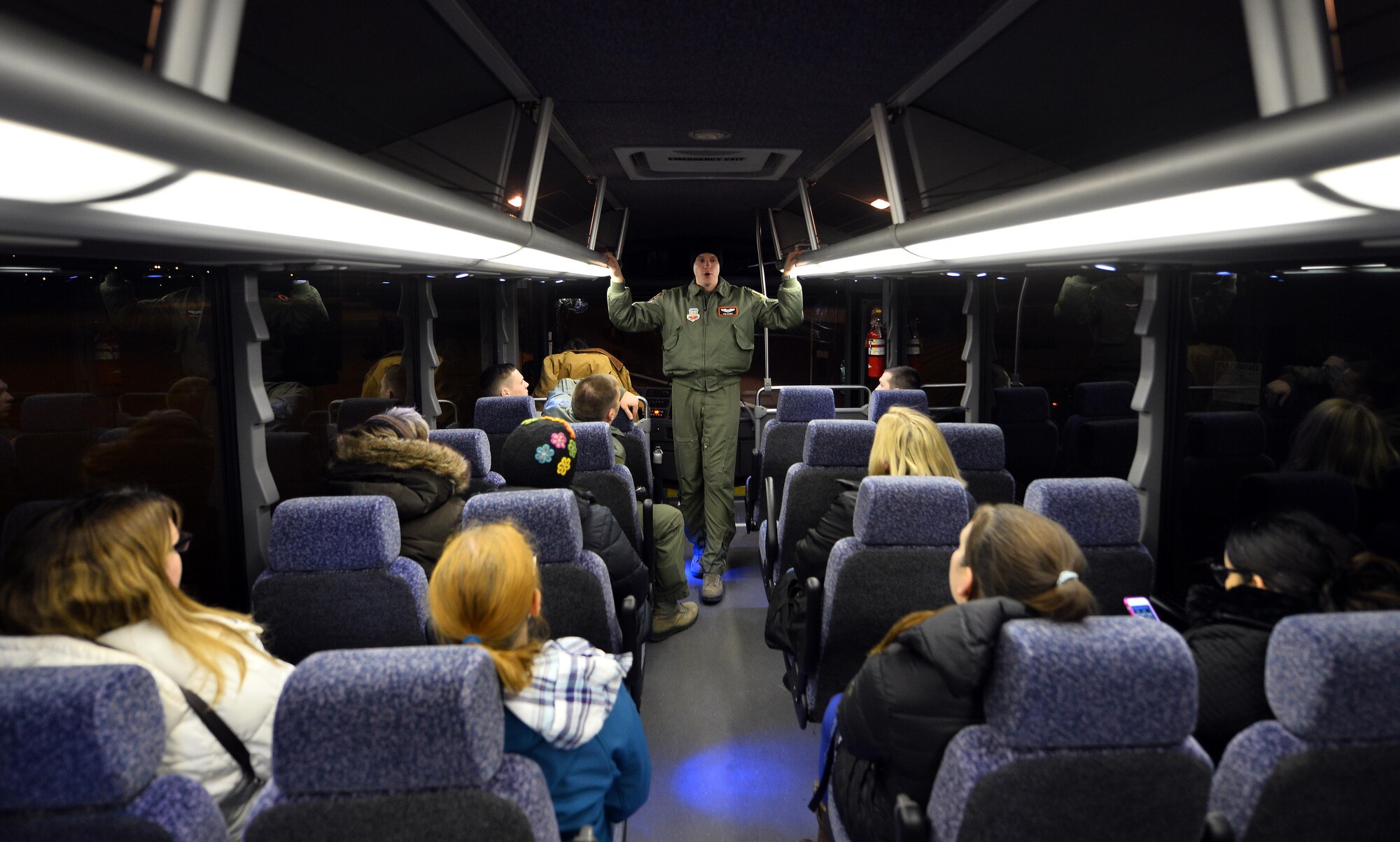 Capt. Tim Kenny, Chief of Central Flight Instructors Course with the 338th Combat Training Squadron, talks with military spouses prior to exiting a bus for a static tour of an RC-135 Aircraft parked in a hangar of the Bennie Davis Maintenance Facility as part of Spouse Appreciation Night, Dec. 7, 2016, at Offutt Air Force Base, Neb. This was the first Wing Spouse Appreciation Night with future tours being scheduled. (U.S. Air Force photo by Josh Plueger)