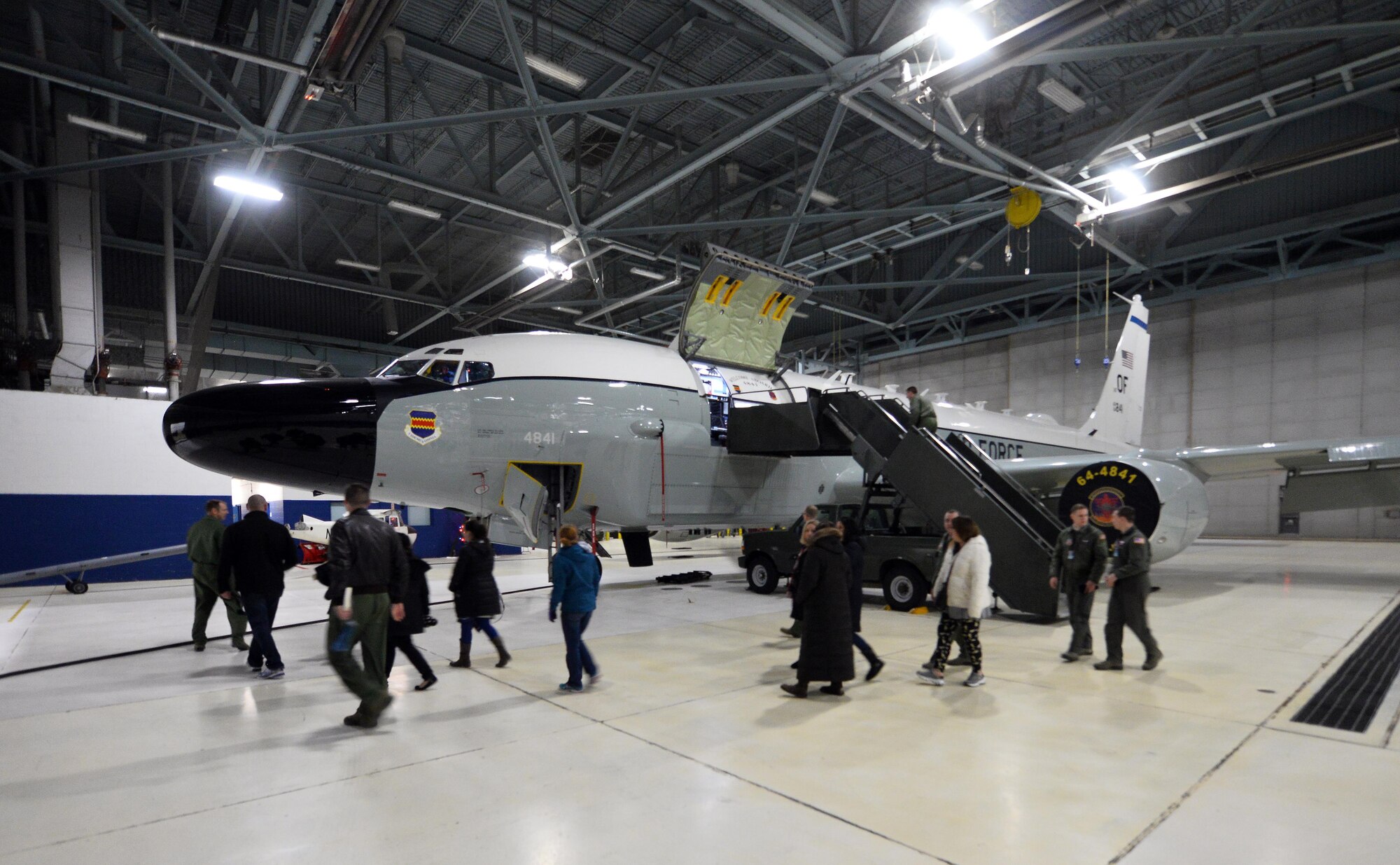 Spouses associated with the 55th Wing get a static tour of an RC-135 Aircraft parked in a hangar of the Bennie Davis Maintenance Facility as part of Spouse Appreciation Night, Dec. 7, 2016, at Offutt Air Force Base, Neb. Spouses of both officers and enlisted Airmen from various squadron participated in the first appreciation night.  Future tours are already being slated for future dates. (U.S. Air Force photo by Josh Plueger)