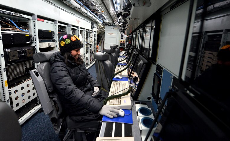 Angela Shermer, wife of Lt. Col. Rich Shermer, commander of the 55th Intelligence Support Squadron, sits at a work station in the fuselage of an RC-135 Rivet Joint aircraft located in the Bennie Davis Maintenance Facility as part of Spouse Appreciation Night, Dec. 7, 2016, at Offutt Air Force Base, Neb. The tour itinerary began with a briefing followed by a state-of-the-art flight simulator and ending with an aircraft tour. (U.S. Air Force photo by Josh Plueger)