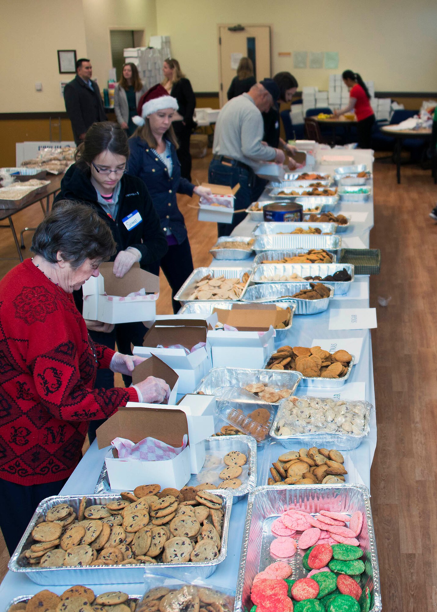 A constant flow of cookies streamed through the door of the First Street Chapel at Travis Air Force Base, Calif., Dec. 7, 2016 during Operation Cookie Drop. Hundreds of volunteers participated in this year’s event by baking, sorting, packaging and delivering thousands of cookies to Travis Airmen. (U.S. Air Force photo/T.C. Perkins Jr.)