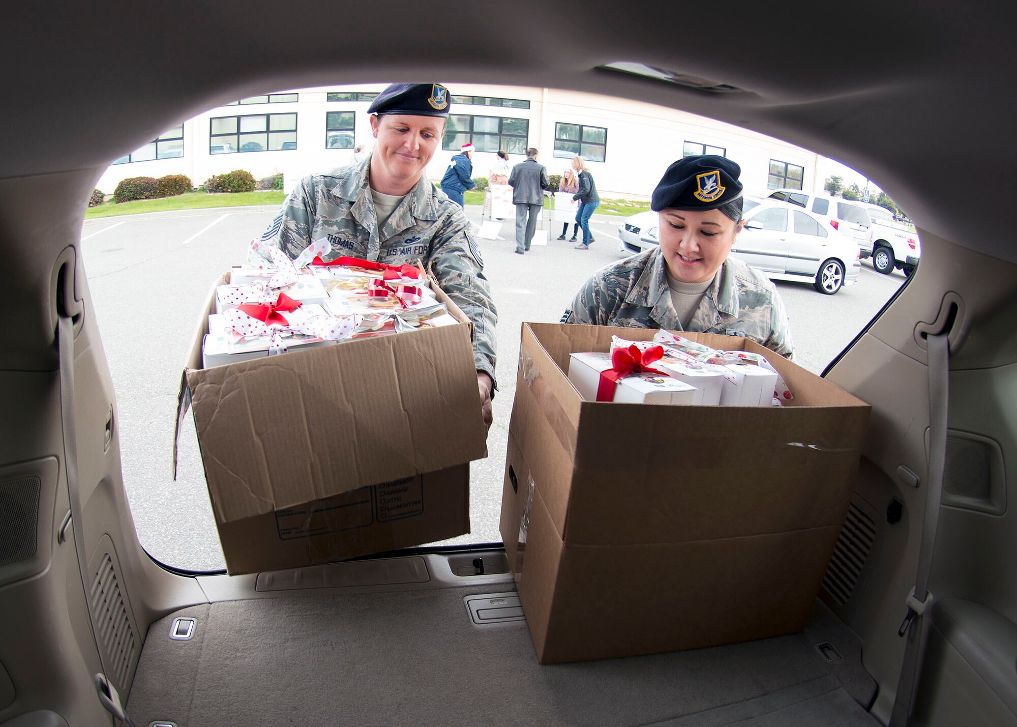 Tech. Sgt. Kristen Thomas and Tech. Sgt. Evelyn Rico, 60th Security Forces Squadron, prepare to transport thousands of cookies to Security Forces Airmen at Travis Air Force Base, Calif., Dec. 7, 2016 during Operation Cookie Drop. Hundreds of volunteers participated in this year’s event by baking, sorting, packaging and delivering thousands of cookies to Airmen all across Travis. (U.S. Air Force Photo/T.C. Perkins Jr.)