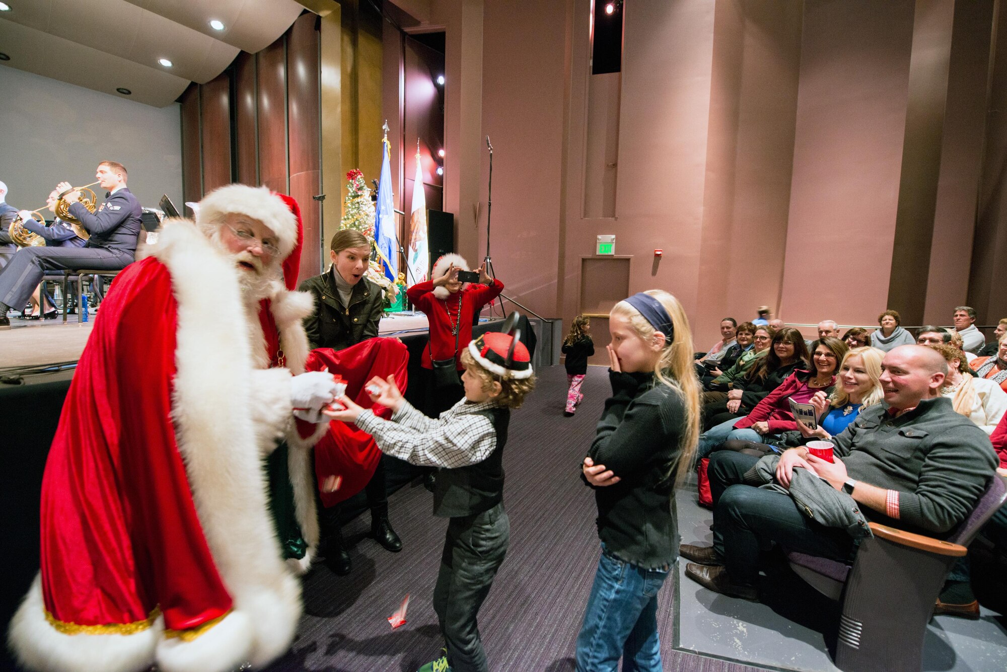 Santa Claus makes an appearance during the U.S. Air Force Band of the Golden West's performance at the Veteran’s Home in Yountville, Calif., Dec. 5, 2016. The performance is part of the band’s annual holiday concert series. This year the band performed six shows over six days at five venues entertaining more than 10,000 people. (U.S. Air Force photo/Louis Briscese)