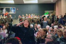A member of the audience salutes during the playing of the Air Force Song as the U.S. Air Force Band of the Golden West from Travis Air Force Base, Calif., performs at the Veteran’s Home in Yountville, Calif., Dec. 5, 2016. The performance was part of the band’s annual holiday concert series. This year the band performed six shows over six days at five venues entertaining more than 10,000 people. (U.S. Air Force photo/Louis Briscese)
