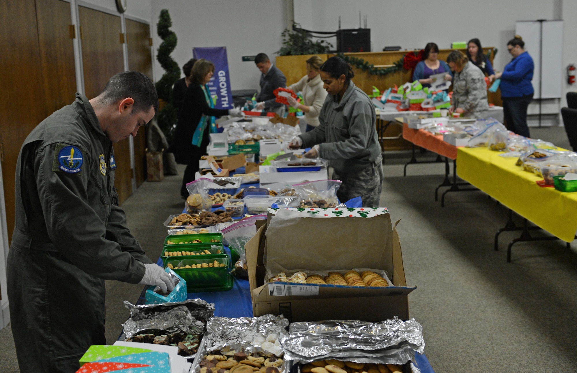 Team McChord volunteers fill boxes with cookies during Operation Cookie Drop Dec. 8, 2016 at McChord Field, Wash. More than 500 boxes were delivered to dorm Airmen while the rest was distributed throughout the units. (U.S. Air Force photo/Senior Airman Divine Cox)