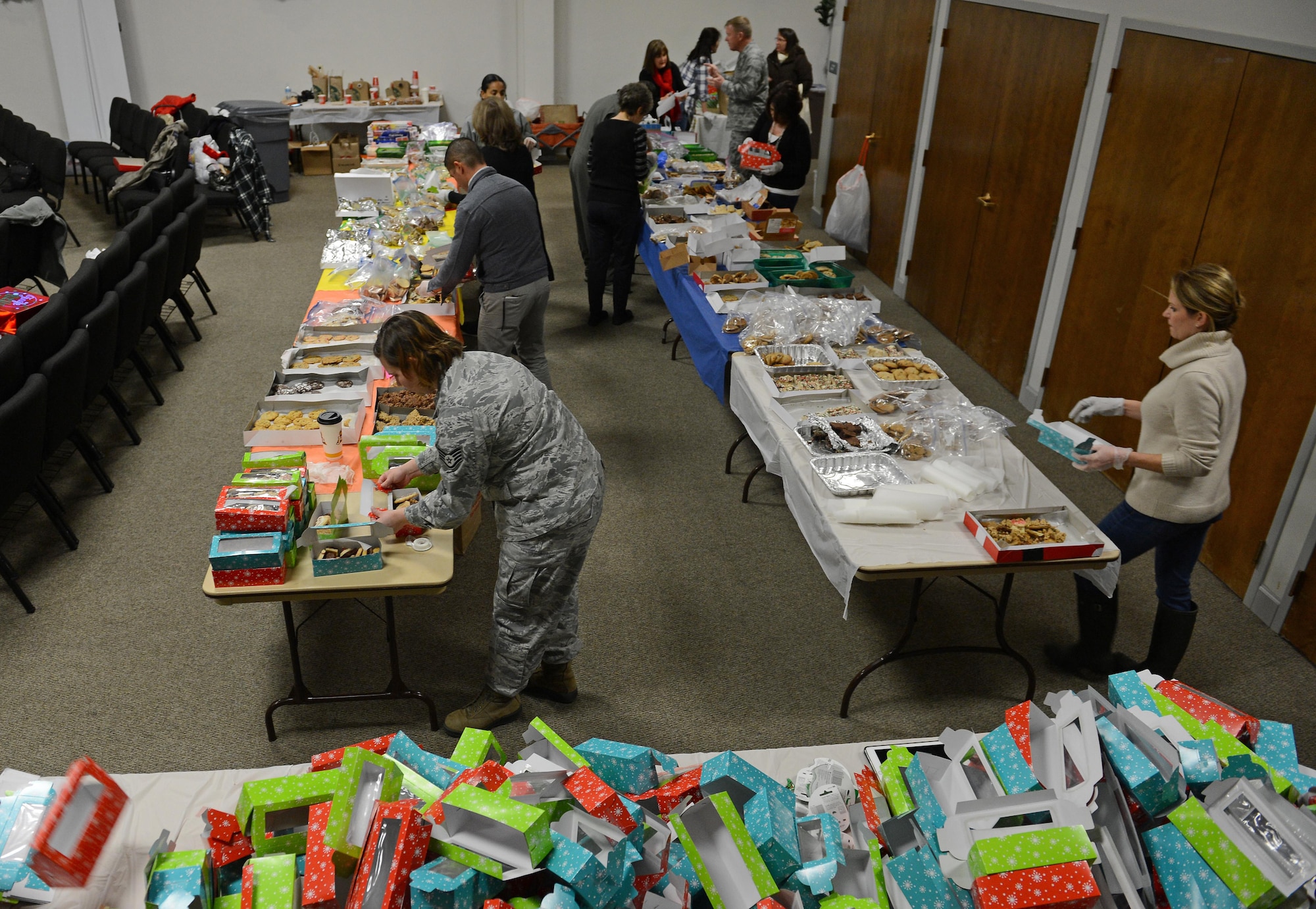 Team McChord volunteers fill boxes with cookies during Operation Cookie Drop Dec. 8, 2016 at McChord Field, Wash. Team McChord volunteers and supporters collected and packaged cookies Dec. 8-9 at the McChord Field Chapel Support Center for first sergeants to deliver to Airmen in the dorms. (U.S. Air Force photo/Senior Airman Divine Cox)