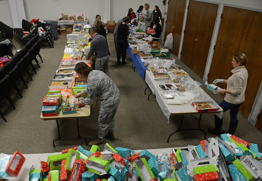 Team McChord volunteers fill boxes with cookies during Operation Cookie Drop Dec. 8, 2016 at McChord Field, Wash. Team McChord volunteers and supporters collected and packaged cookies Dec. 8-9 at the McChord Field Chapel Support Center for first sergeants to deliver to Airmen in the dorms. (U.S. Air Force photo/Senior Airman Divine Cox)