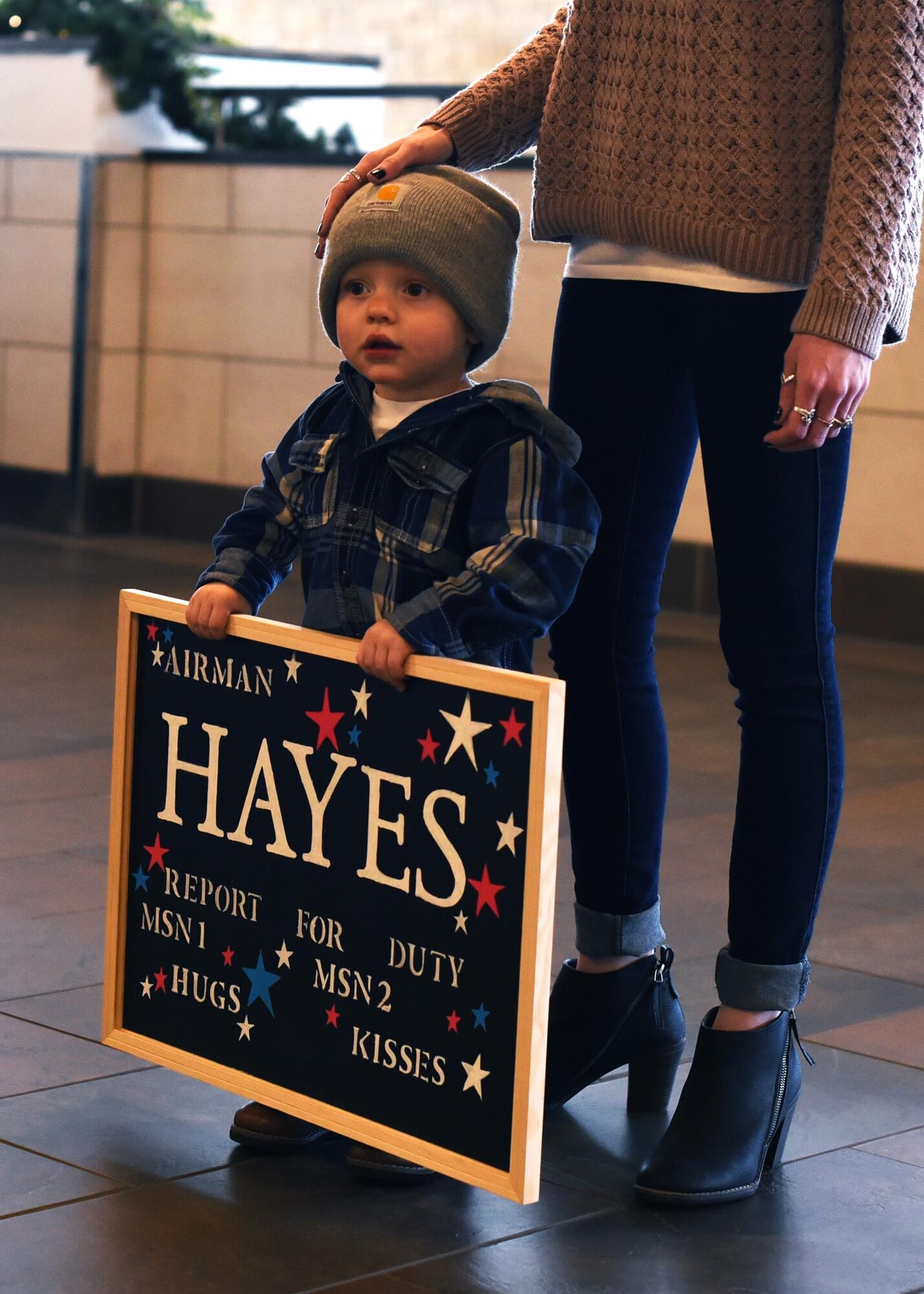 Steven Hayes Jr., 2, holds a sign for his dad Dec. 9, 2016, in Grand Forks, N.D. Steven and his mom, Lane, spent the last six months separated from their father and husband Senior Airman Steven Hayes, 69th Maintenance Squadron aircraft maintenance journeyman, while he was deployed. (U.S. Air Force photo by Senior Airman Ryan Sparks)