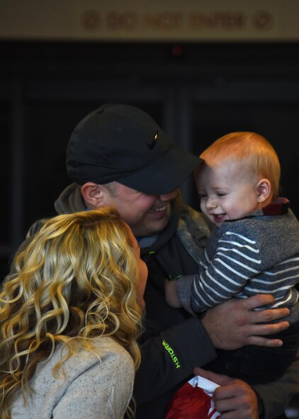 Staff Sgt. Brandon Peterson, 69th Maintenance Squadron aircraft maintenance craftsman, hugs his son Kayden, 1, Dec. 9, 2016, in Grand Forks, N.D. Peterson spent the last six months deployed and wasn’t able to see son or wife, Hailey. (U.S. Air Force photo by Senior Airman Ryan Sparks)