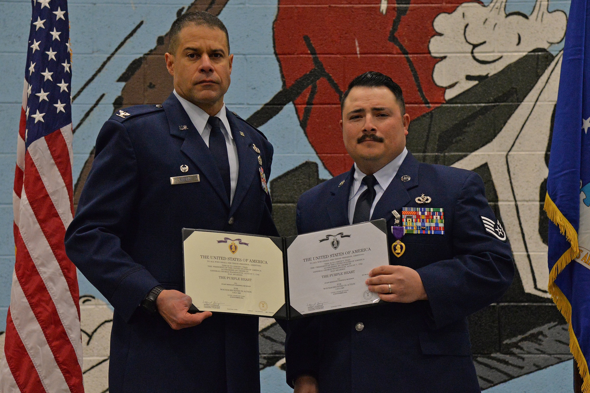 Col. Jose Rivera, 819th RED HORSE Squadron commander, left, and Staff Sgt. Joseph Dickison, 819th RHS heating, ventilation and air conditioning technician, pose for a photo at a Purple Heart medal ceremony Dec. 9, 2016, at Malmstrom Air Force Base, Mont. Dickison was awarded the Purple Heart for combat wounds received in Afghanistan in July 2009. (U.S. Air Force photo/Airman 1st Class Daniel Brosam)
