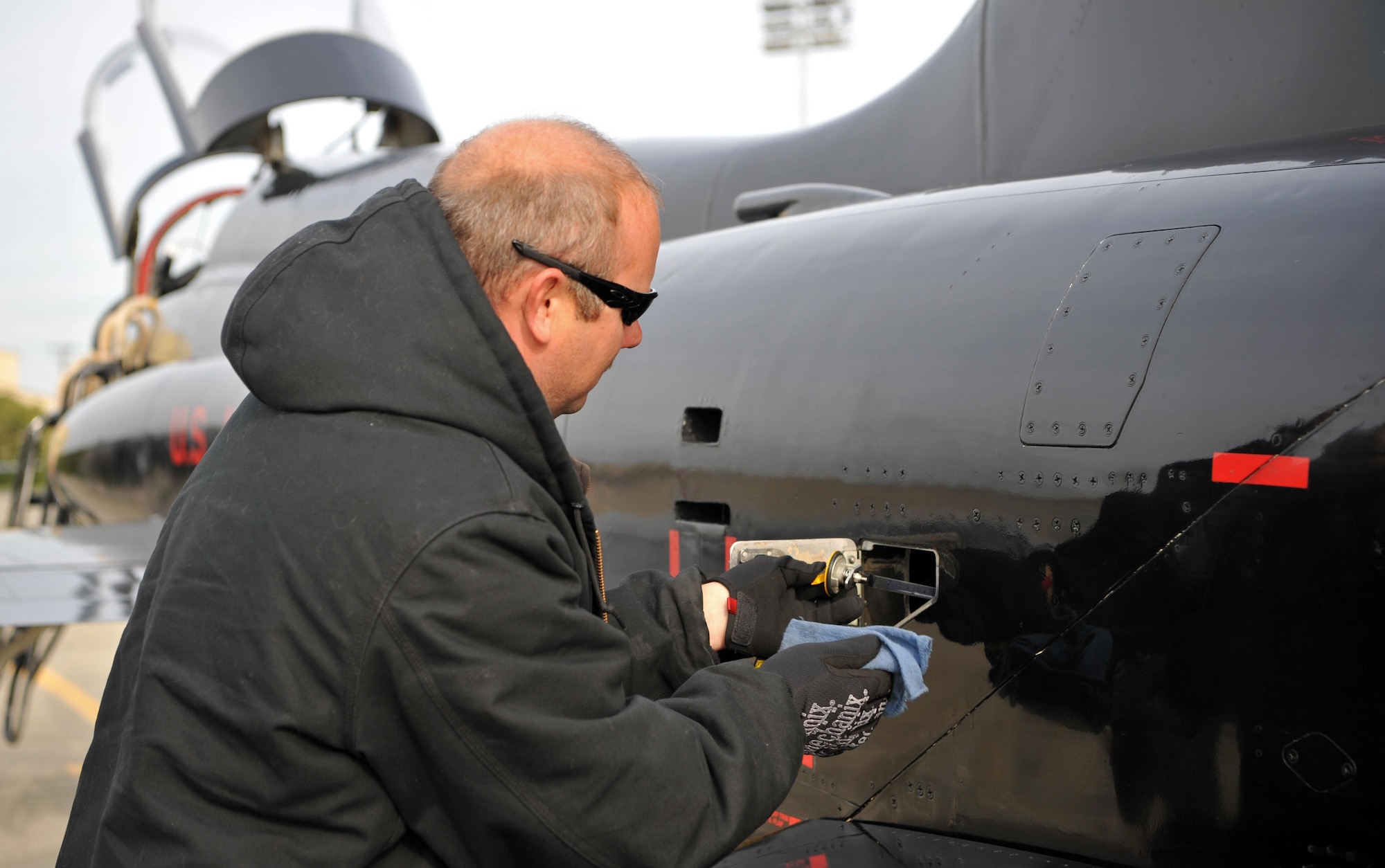 Matt Miller, 9th Maintenance Group T-38 aircraft mechanic, checks the oil in a T-38 Talon engine during a post-flight inspection Dec. 5, 2016, at Beale Air Force Base, California. The mechanics take an oil sample from T-38 engines every 20 flight hours. (U.S. Air Force Photo/Airman Tristan D. Viglianco)