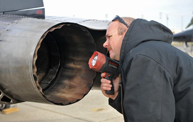 Matt Miller, a 9th Maintenance Group T-38 aircraft mechanic, checks for cracks in a T-38 Talon’s exhaust during a post-flight inspection Dec. 5, 2016, at Beale Air Force Base, Calif. The exhaust may form cracks from expansion and contraction due to repeated heated and cooling. (U.S. Air Force Photo/Airman Tristan D. Viglianco)