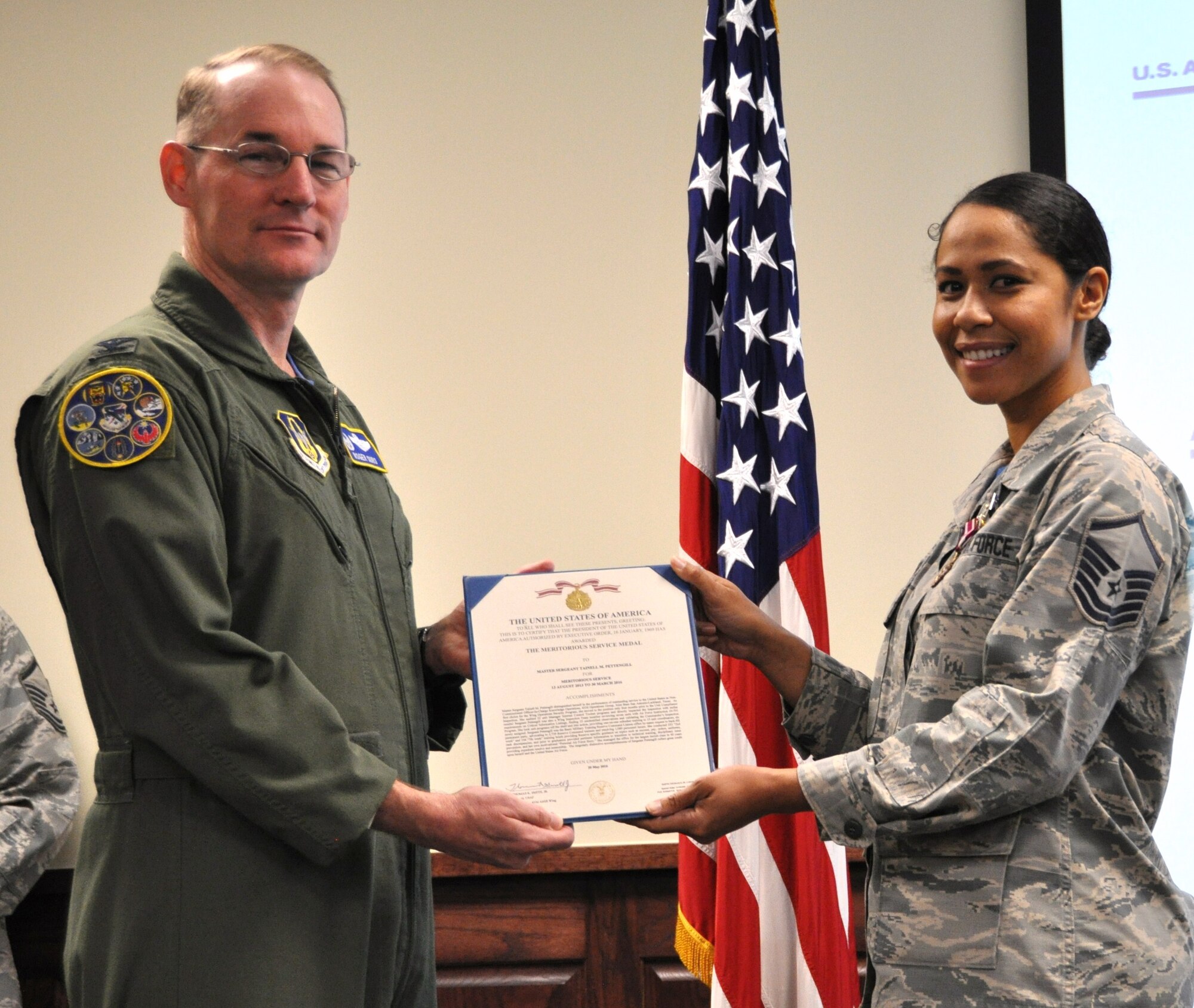 Col. Roger Suro, 340th FTG commander presents a Meritorious Service Medal to Master Sgt. Tainell Pettengill during  the Group's MUTA held Dec. 1-2 at Joint Base San Antonio-Randolph, Texas (Photo by Janis El Shabazz).