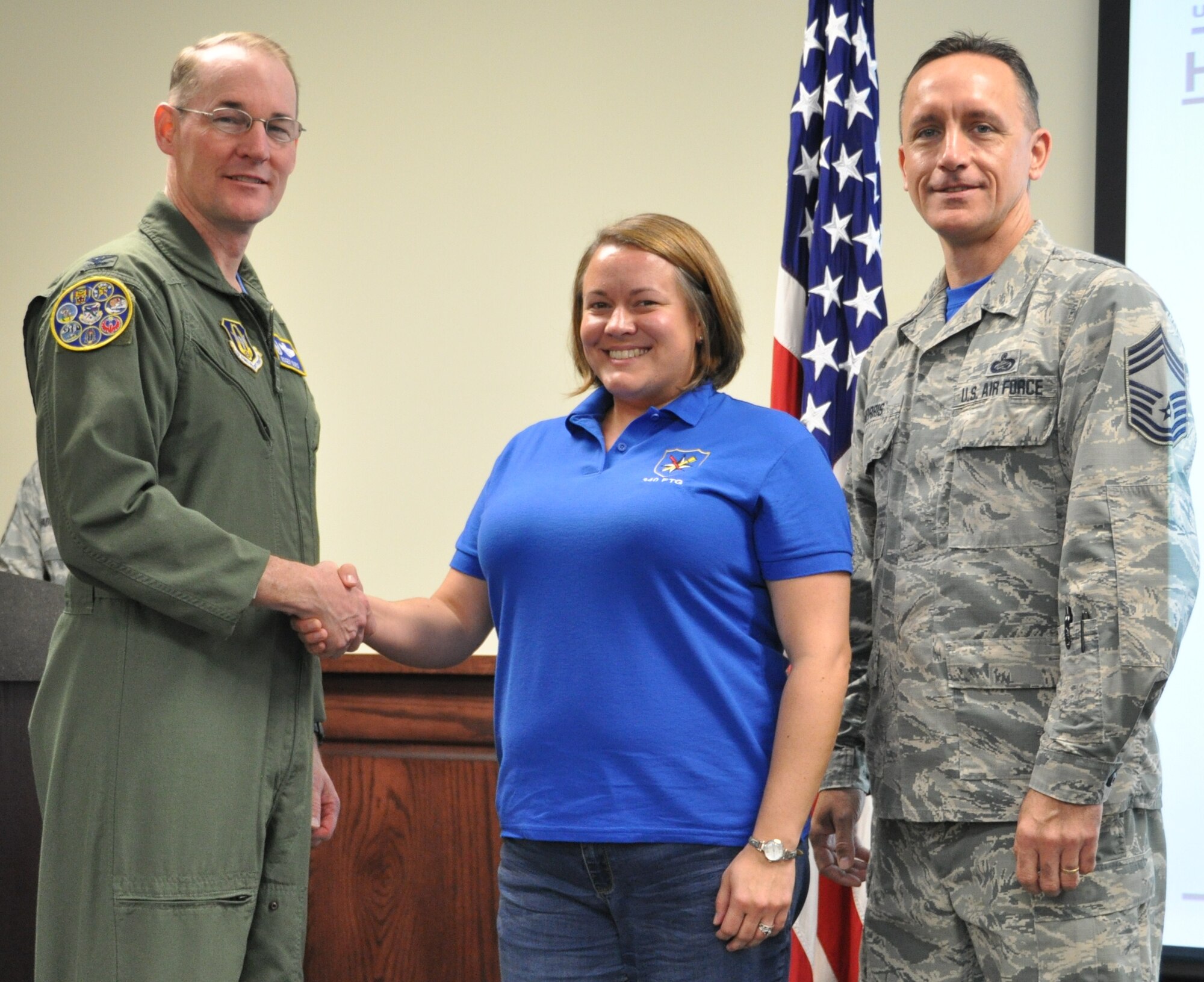 Col. Roger Suro, 340 FTG commander congratulates Kristal Gault for multiple public affairs communication excellence awards from USAFE-AFRICA during the Group's MUTA held Dec. 1-2 at Joint Base San Antonio-Randolph, Texas (Photo by Janis El Shabazz).