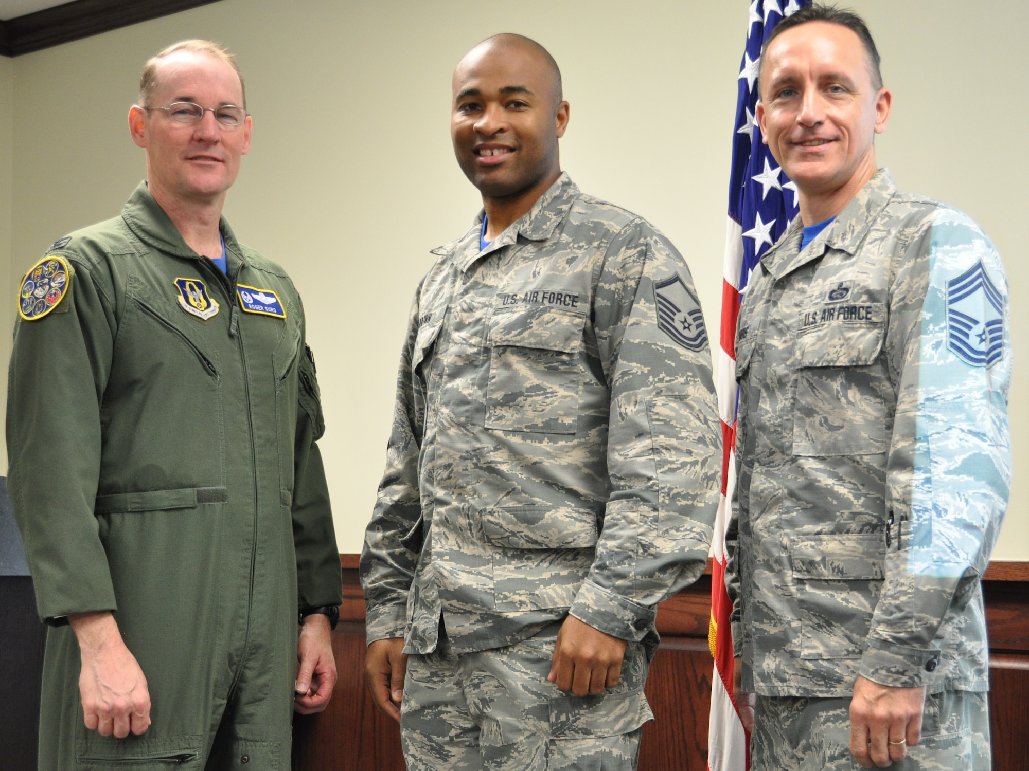 Master Sgt. Gregory Brown stands with 340th FTG commander, Col. Roger Suro (L) and Chief Master Sgt. Jimmie Morris, group superintendent to receive a Joint Service Achievement Medal during the Group's MUTA held Dec. 1-2 at Joint Base San Antonio-Randolph, Texas (Photo by Janis El Shabazz).