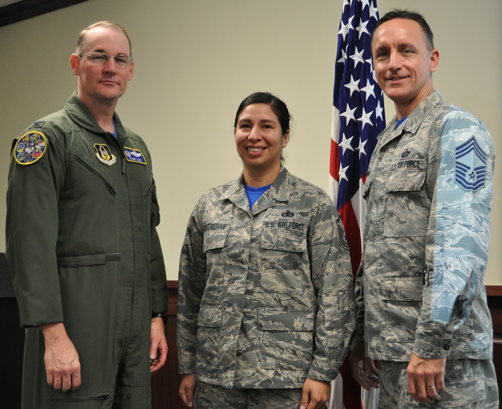 Master Sgt. Vianca Contreras stands with Col. Roger Suro, 340th FTG commander and group superintendent, Chief Master Sgt. Jimmie Morris to receive  a diamond sharp award for the 2nd quarter during the group’s Dec. 1 MUTA at Joint Base San Antonio-Randolph, Texas (Photo by Janis El Shabazz).