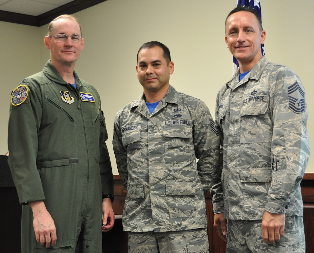Master Sgt. Gilberto Hernandez stands with Col. Roger Suro, 340th FTG commander and group superintendent, Chief Master Sgt. Jimmie Morris during the group’s Dec. 1 MUTA at Joint Base San Antonio-Randolph, Texas  to recognize his selection as a 2016 AFRC Lance P. Sijan nominee (Photo by Janis El Shabazz).