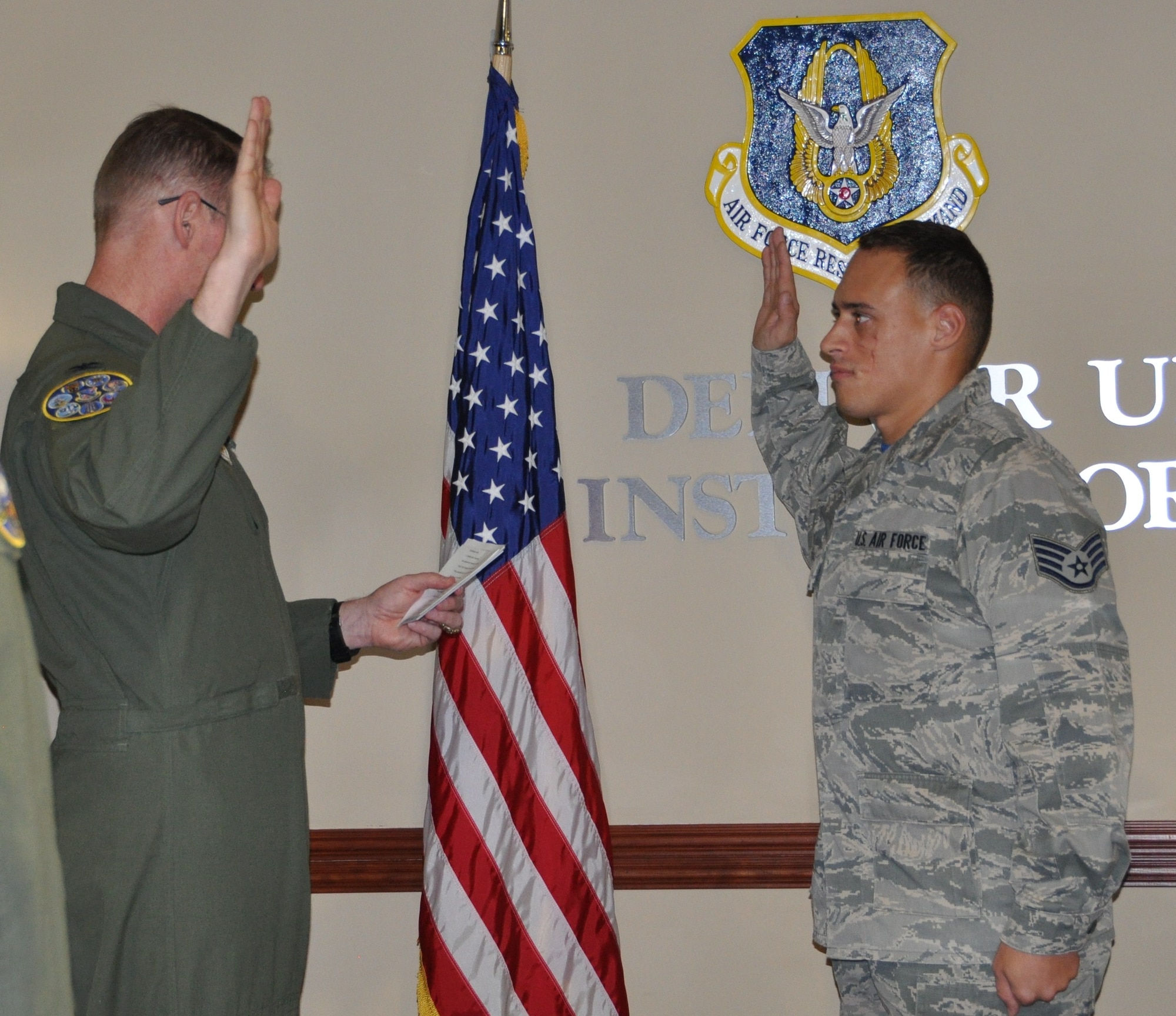 Staff Sgt.  Brett Daniel being promoted to Tech. Sgt. by Col. Roger Suro, 340th FTG commander at the Group's MUTA held Dec. 1-2 at Joint Base San Antonio-Randolph, Texas (Photo by Janis El Shabazz).