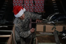 U.S. Air Force Chief Master Sgt. Todd Donaldson, 515th Air Mobility Operations Wing Command Chief, based out of Joint Base Pearl Harbor-Hickam, Hawaii, signs a box of donated goods en route to one of the 54 Micronesian islands as a part of the 65th Operation Christmas Drop Dec. 6, 2016. Operation Christmas Drop is the longest running humanitarian airlift operation in the history of the Department of Defense, impacting the lives of more than 20,000 islanders. The people of the Micronesian islands can expect to see service members aboard a C-130 Hercules drop a box, attached to a parachute, filled with rice, fish hooks, educational materials, clothing and toys. (U.S. Air Force photo by Master Sgt. Theanne Herrmann)