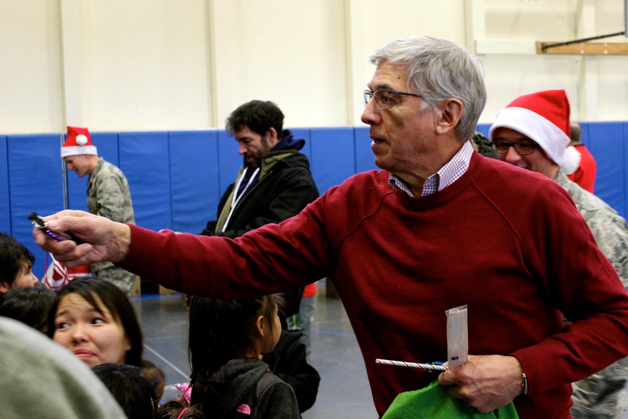 Lt. Gov. Byron Mallot hands out donated items to members of the Akiachak community during Operation Santa Claus, Dec. 3, 2016. This year marked the 60th year in which the Alaska National Guard supported Operation Santa Claus with logitics and air support, delivering holiday cheer and gifts to remote Alaska villages. (U.S. Army National Guard photo by Capt. Amanda Plachek)
