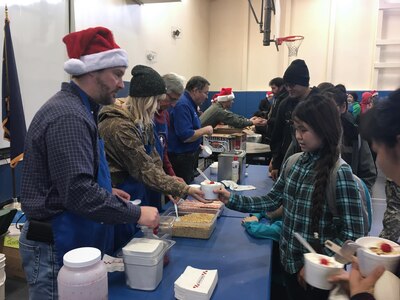 Volunteers for Operation Santa Claus make sundaes for children in Akiachak Dec. 3, 2016. The Alaska National Guard community relations program is an annual event in it's 60th year of visiting rural villages throughout the state. (U.S. Air National Guard photo by Lt. Col. Candis Olmstead)