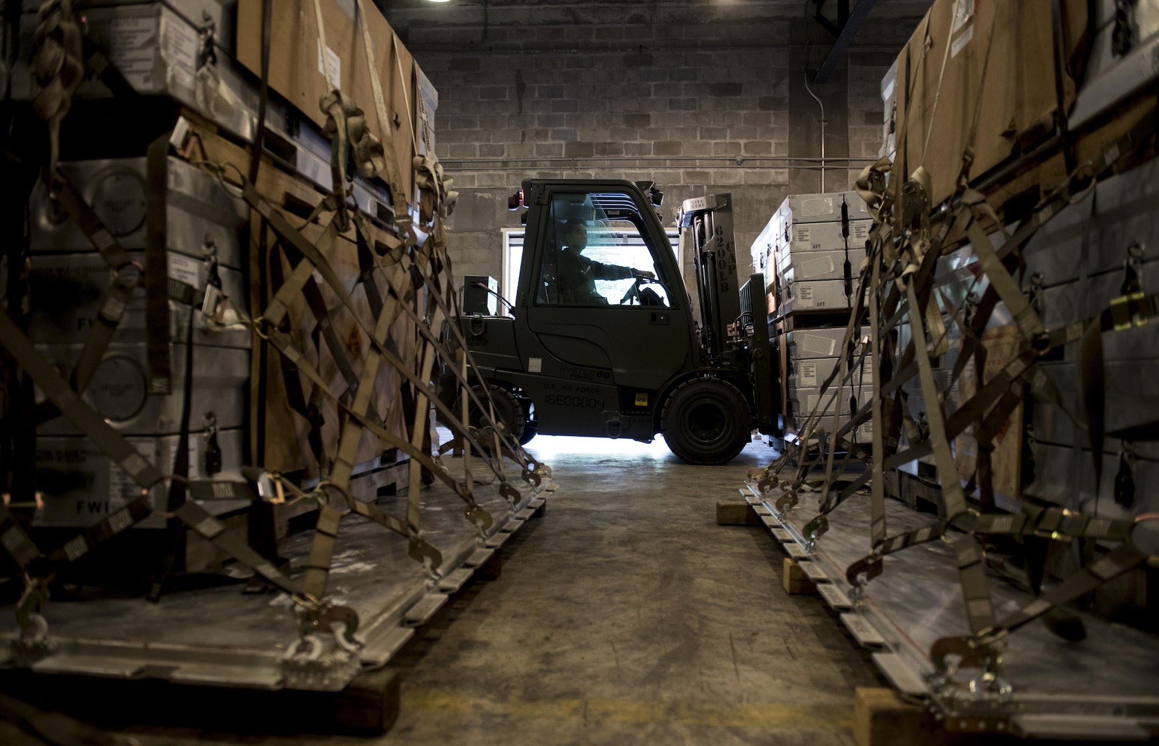 A forklift transports munitions during a Tactical Ammunition Rapid Response Package exercise Dec. 6, 2016, at Kadena Air Base, Japan. To pass the exercise, each completed pallet must receive proper inspection and information documentation by Airmen of the 18th Munitions Squadron, together with the 18th Logistics Readiness Squadron and 733rd Air Mobility Squadron. (U.S. Air Force photo by Senior Airman Omari Bernard/Released)