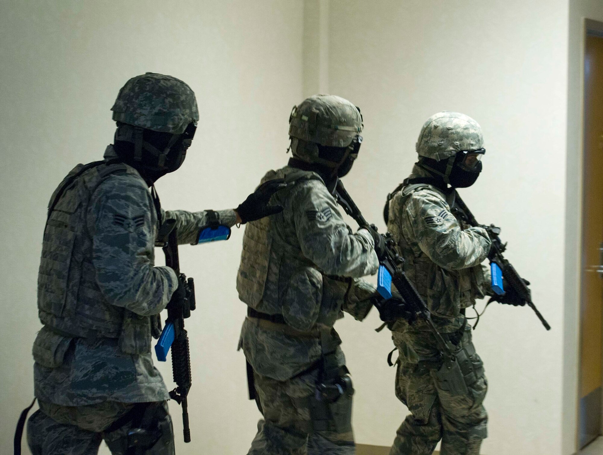 The 446th Security Forces Squadron trains to enter a building during an Active Shooter exercise at Joint Base Lewis-McChord, Dec. 3. Among the most vital purposes of the exercise was to validate the efficacy of the Shoot Move Communicate training to include the use of reasonable force. During the exercise Quick Response Forces reacted and had to make split-second decisions about the level of force that was necessary to engage in. (U.S. Air Force Reserve photo by Staff Sgt. Daniel Liddicoet)
