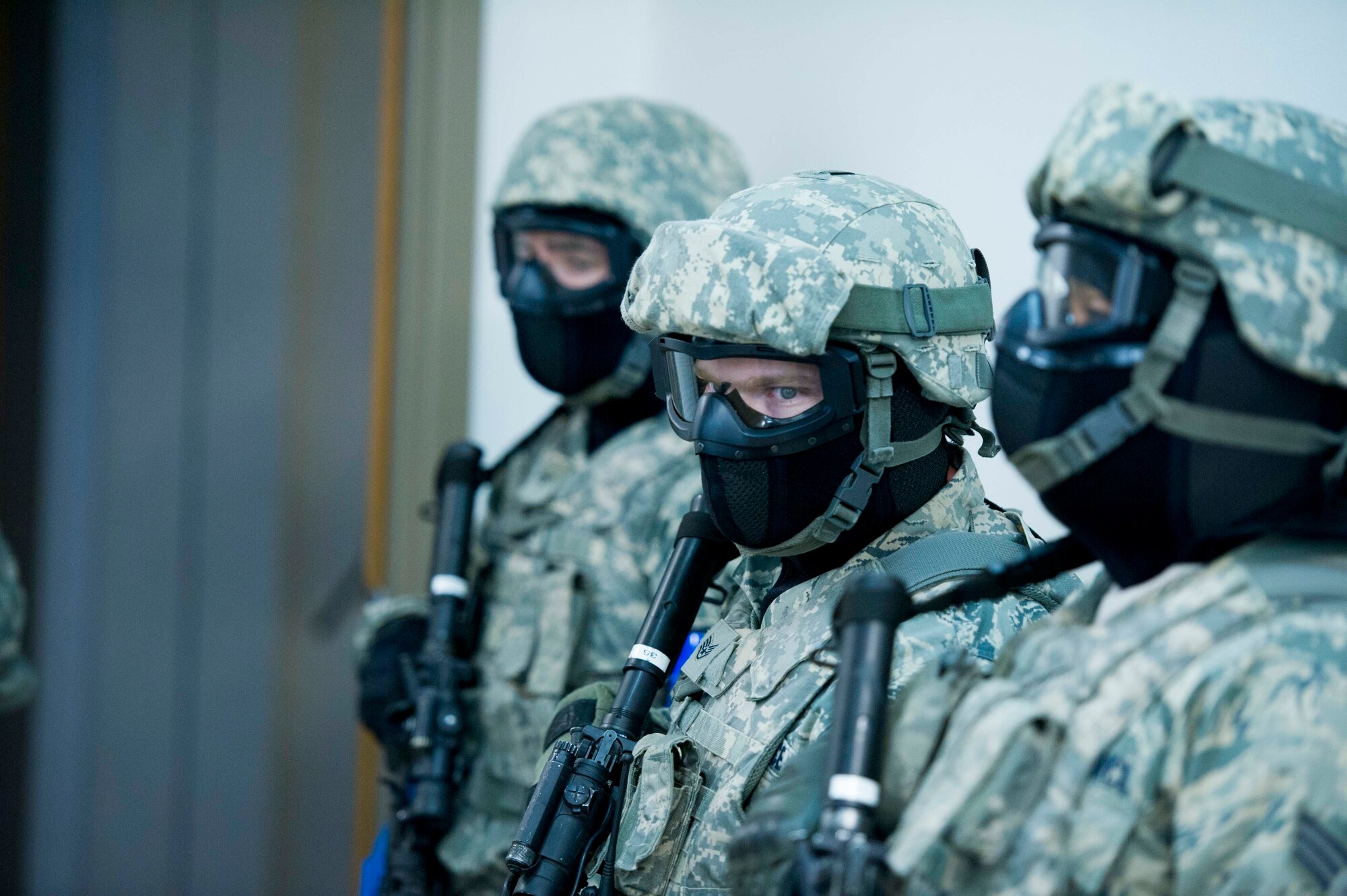 The 446th Security Forces Squadron trains to enter a building during an Active Shooter exercise at Joint Base Lewis-McChord, Dec. 3. Among the most vital purposes of the exercise was to validate the efficacy of the Shoot Move Communicate training to include the use of reasonable force. During the exercise Quick Response Forces reacted and had to make split-second decisions about the level of force that was necessary to engage in. (U.S. Air Force Reserve photo by Staff Sgt. Daniel Liddicoet)