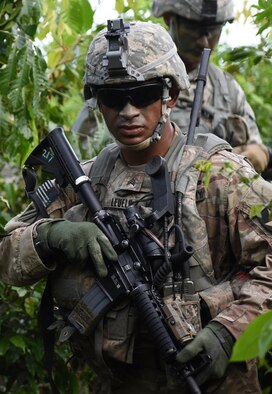 U.S. Army Sgt. Sania Leuelu, squad leader for 1st Squad, 1st Platoon, Alpha Company, 4th Battalion, 23rd Infantry Regiment, 2nd Stryker Brigade Combat Team, 2nd Infantry Division, treks through high brush during a squad live-fire exercise Nov. 18, 2016, at Andersen Air Force Base, Guam. The exercise assesses a squad’s ability to navigate, communicate and apply tactical and infantrymen skills to seize a bunker. (U.S. Air Force photo by Airman 1st Class Jacob Skovo)