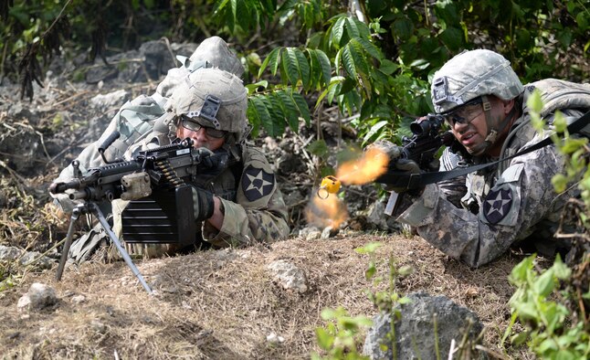 U.S. Army Sgt. Shane Fay, team leader for 1st Squad, 1st Platoon, Alpha Company, 4th Battalion, 23rd Infantry Regiment, 2nd Stryker Brigade Combat Team, 2nd Infantry Division, secures a wooded area during a squad live-fire exercise Nov. 18, 2016, at Andersen Air Force Base, Guam. Soldiers fired blanks at opposing forces, followed by live-fire at simulated targets during daylight and at night. (U.S. Air Force photo by Airman 1st Class Jacob Skovo)