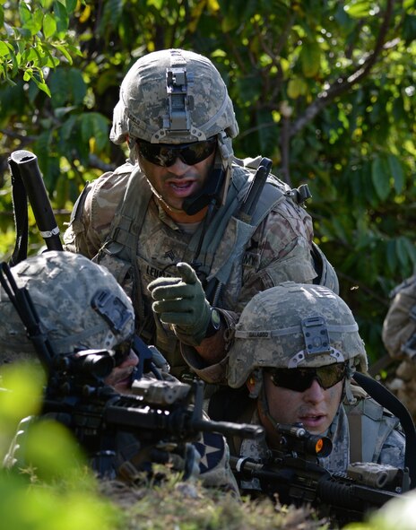 U.S. Army Sgt. Sania Leuelu, squad leader for 1st Squad, 1st Platoon, Alpha Company, 4th Battalion, 23rd Infantry Regiment, 2nd Stryker Brigade Combat Team, 2nd Infantry Division, directs the fire of his team during a squad live-fire exercise Nov. 18, 2016, at Andersen Air Force Base, Guam. Effective communication between teams is crucial to the safe execution of live-fire training. (U.S. Air Force photo by Airman 1st Class Jacob Skovo)