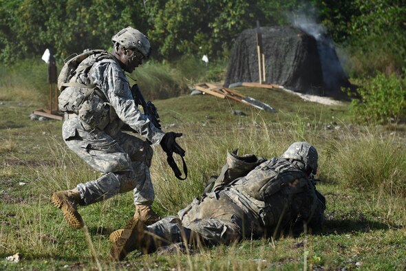 U.S. Army Sgt. Andre Ried, left, and U.S. Army Pfc. Steven Duron, both from the 1st Squad, 1st Platoon, Alpha Company, 4th Battalion, 23rd Infantry Regiment, 2nd Stryker Brigade Combat Team, 2nd Infantry Division, flank a bunker during a squad live-fire exercise Nov. 18, 2016, at Andersen Air Force Base, Guam. The small team flanked a bunker, from a blind spot, as the rest of the squad suppressed simulated targets. Soldiers are assessed quarterly on their ability to navigate, communicate, and apply tactical and infantrymen skills. (U.S. Air Force photo by Airman 1st Class Jacob Skovo)