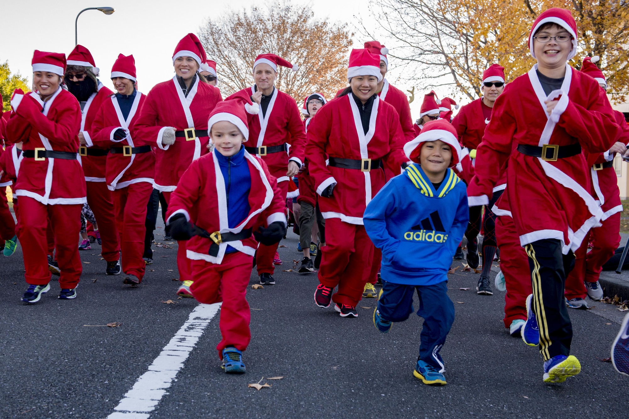 Participants start running during the Santa Shuffle 5K Fun Run Dec. 10, 2016, at Yokota Air Base, Japan. The event was the first time the Yokota Striders organized the holiday themed fun run and provided Santa hats and outfits for participants. (U.S. Air Force photo by Airman 1st Class Donald Hudson/Released)