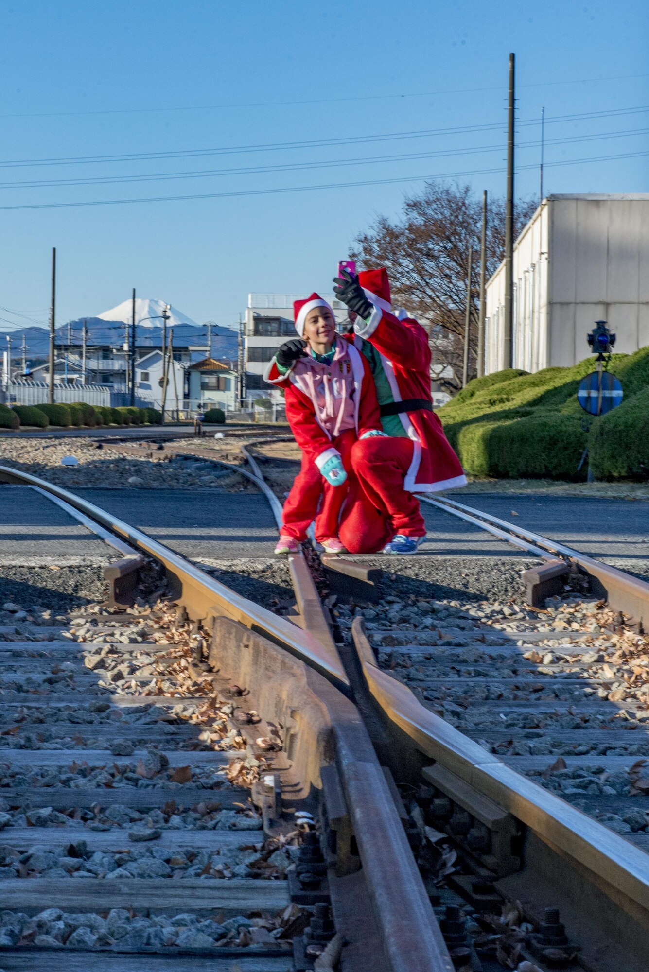 Participants stop to take a photo with Mt. Fuji in the background during the Santa Shuffle 5K Fun Run Dec. 10, 2016, at Yokota Air Base, Japan. Volunteers with the Yokota Striders running club organized the event to promote running and a healthy lifestyle. (U.S. Air Force photo by Airman 1st Class Donald Hudson/Released)