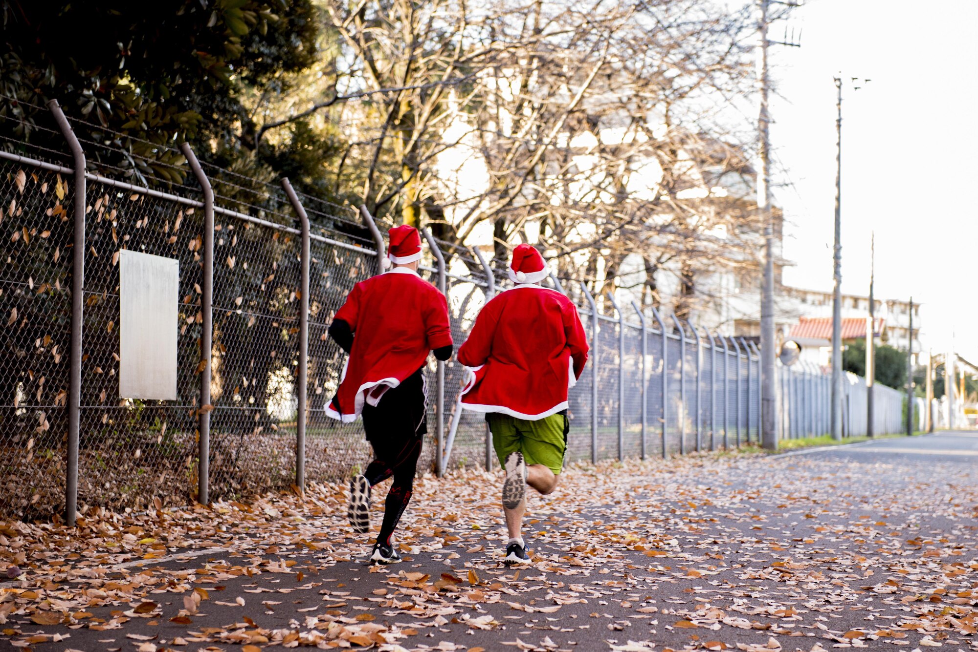 Participants run during the Santa Shuffle 5K Fun Run Dec. 10, 2016, at Yokota Air Base, Japan. The event was the first time the Yokota Striders organized the holiday themed fun run and provided Santa hats and outfits for participants. (U.S. Air Force photo by Airman 1st Class Donald Hudson/Released)