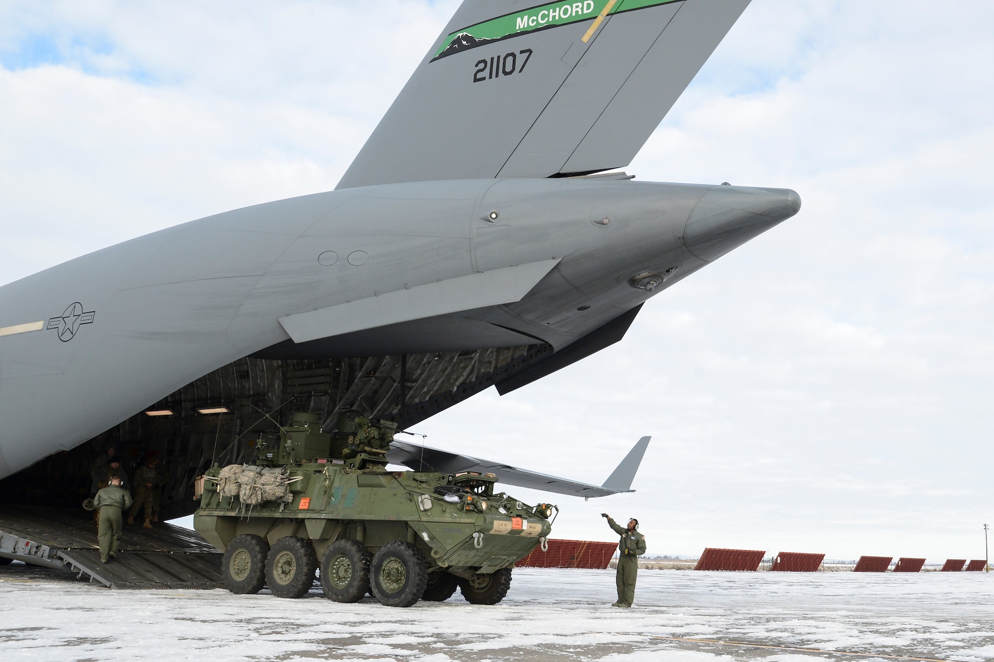 Staff Sgt. Seth Lewis, 7th Airlift Squadron loadmaster, unloads a 7th Infantry Division Stryker onto the snowy ramp at Moses Lake, Wash., during the Rainier War exercise Dec. 7, 2016. In the exercise scenario, Moses Lake was a U.S.-held airfield in hostile territory which required a resupply of equipment and supplies. (U.S. Air Force photo/Tech. Sgt. Sean Tobin)