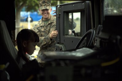 An Okinawa resident sits in a Humvee Nov. 20, 2016 during the Japan Ground Self-Defense Force Festival on Camp Naha, Okinawa, Japan. The festival celebrated the 6th anniversary of the 15th Brigade and the 44th anniversary of Camp Naha. The Humvee was one of three vehicles Marines with Combat Assault Battalion, 3rd Marine Division, III Marine Expeditionary Force brought for display. (U.S. Marine Corps photo by Cpl. Jessica Collins) 
