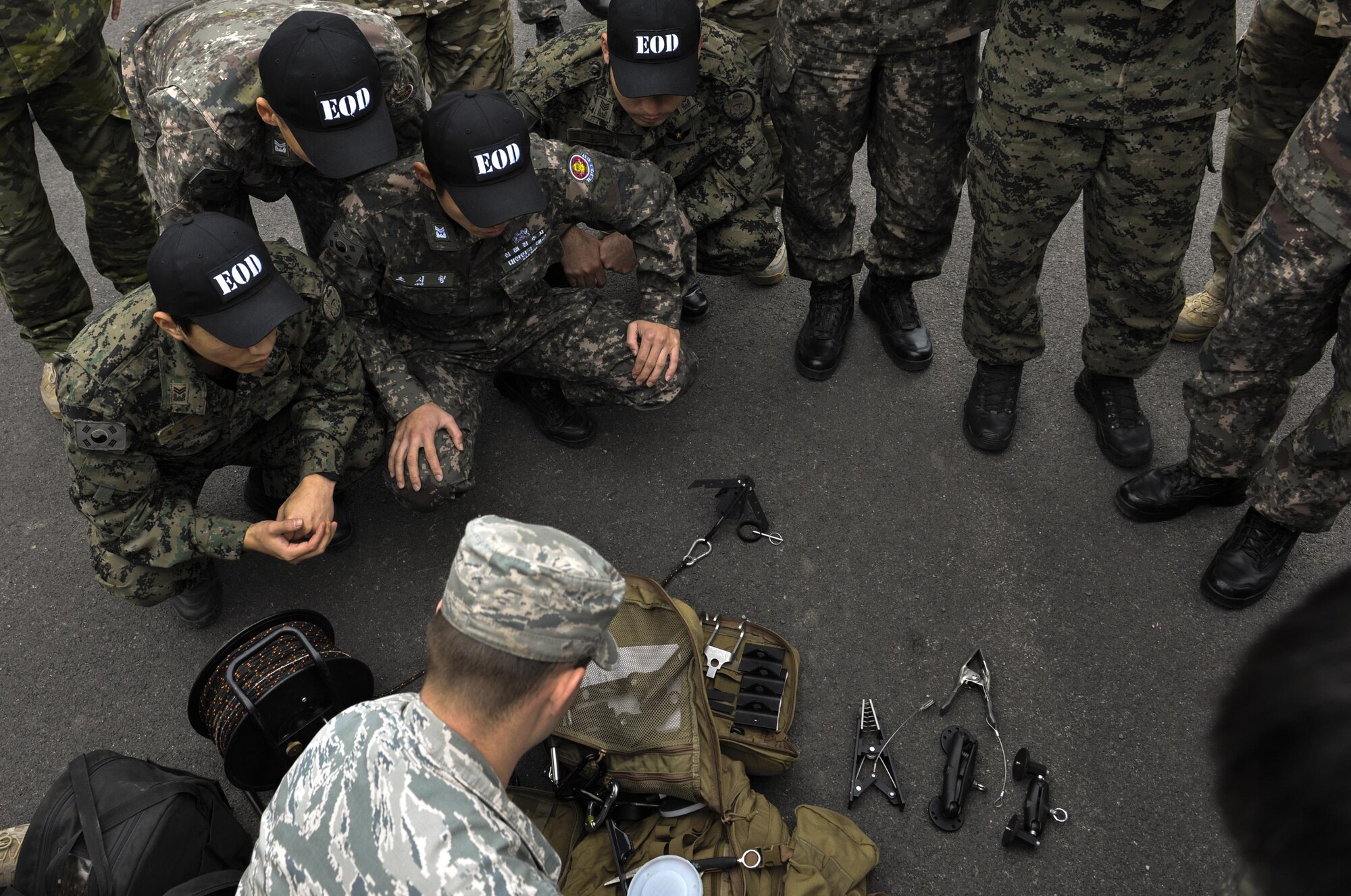 U.S. Air Force Staff Sgt. William Riddle, 8th Civil Engineer Squadron explosive ordinance disposal technician, displays U.S. EOD equipment to Republic of Korea Air Force EOD at Kunsan Air Base, Republic of Korea, Nov. 7, 2016. ROKAF EOD members visited with the U.S. EOD team to learn how they train and what tools and techniques they use. (U.S. Air Force photo by Senior Airman Colville McFee/Released)