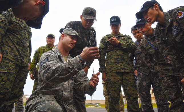 U.S. Air Force Staff Sgt. William Riddle, 8th Civil Engineer Squadron explosive ordinance disposal technician, displays U.S. EOD equipment to Republic of Korea Air Force EOD  members at Kunsan Air Base, Republic of Korea, Nov. 7, 2016. ROKAF EOD members visited with the U.S. EOD  team to learn how they train and what tools and techniques they use. (U.S. Air Force photo by Tech. Sgt. Jeff Andrejcik/Released)
