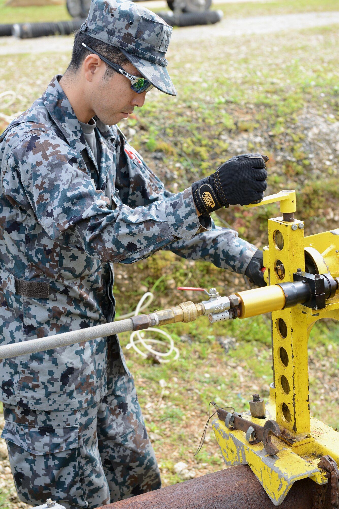 Japan Air Self-Defense Force Staff Sgt. Kentaro Ikeda repairs a fuel line during Silver Flag Dec. 1, 2016, at Northwest Field, Guam. Silver Flag is designed to engage, exercise and train with partner nation civil engineers to strengthen and increase interoperability. (U.S. Air Force photo by Senior Airman Arielle K. Vasquez/Released)