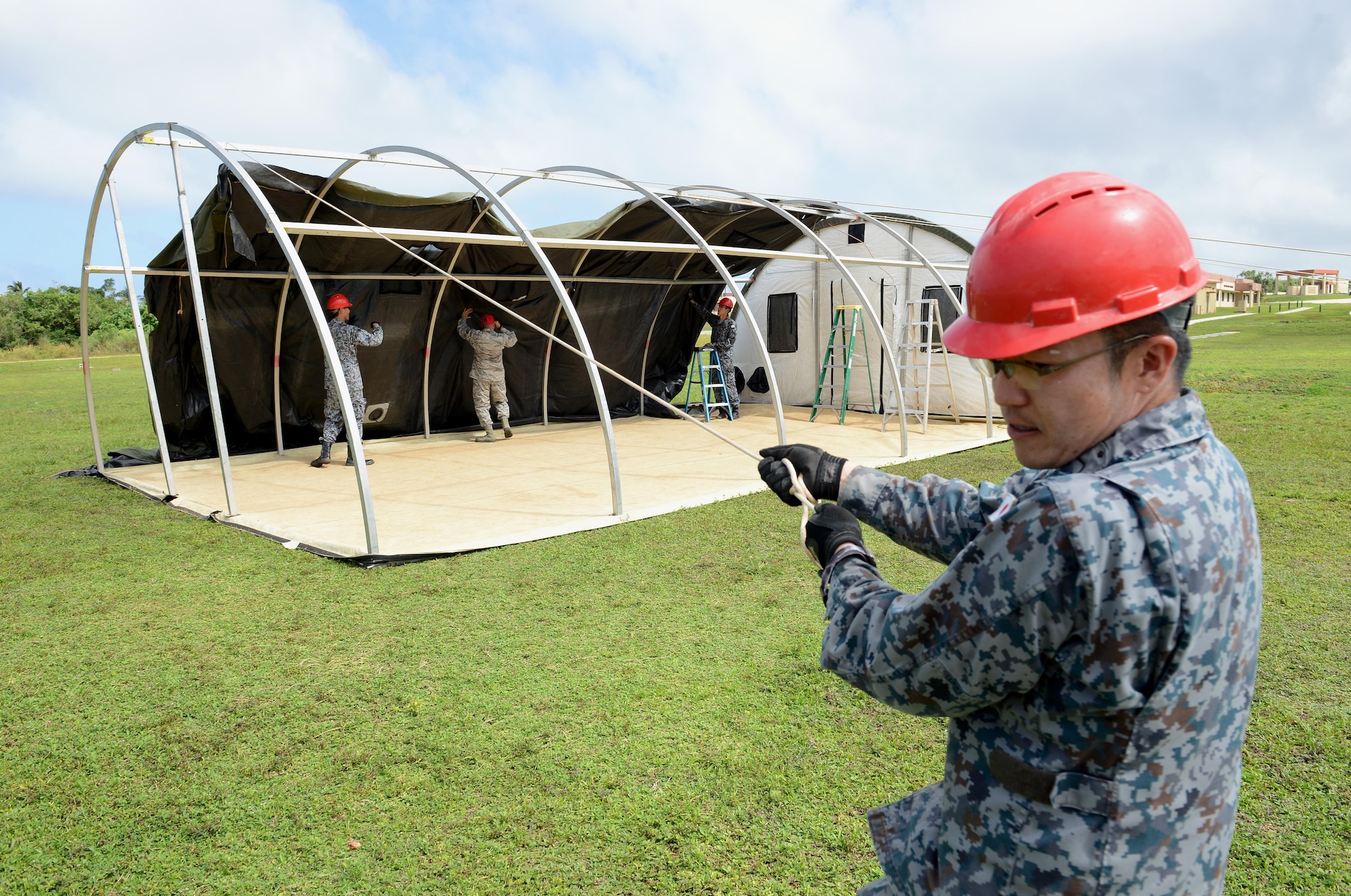 Japan Air Self-Defense Force Staff Sgt. Makoto Mizuhara pulls on a rope during Silver Flag Dec. 5, 2016, at Northwest Field, Guam. U.S. Air Force and JASDEF Airmen spent a week sharing civil engineering techniques to build partnerships and promote interoperability. (U.S. Air Force photo by Senior Airman Arielle K. Vasquez/Released)