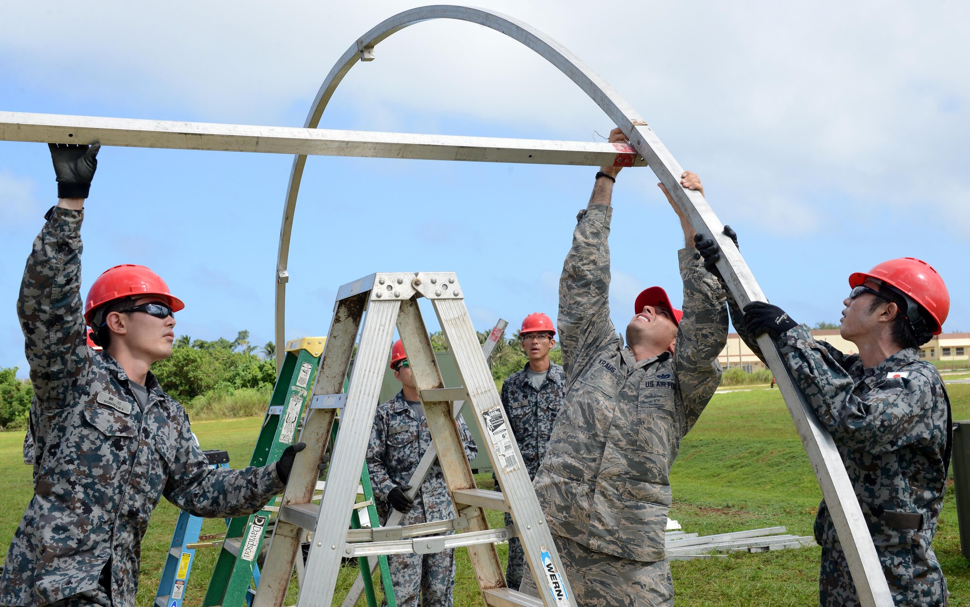 U.S. Air Force and Japan Air Self-Defense Force Airmen assemble frames during Silver Flag Dec. 5, 2016, at Northwest Field, Guam. U.S. Pacific Command’s partner nation Silver Flag training classes are held to promote mutual understanding between partner nations and PACAF civil engineers' missions, capabilities and objectives. (U.S. Air Force photo by Senior Airman Arielle K. Vasquez/Released)