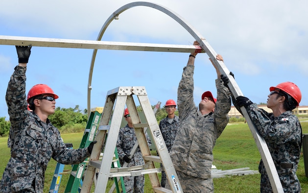 U.S. Air Force and Japan Air Self-Defense Force Airmen assemble frames during Silver Flag Dec. 5, 2016, at Northwest Field, Guam. U.S. Pacific Command’s partner nation Silver Flag training classes are held to promote mutual understanding between partner nations and PACAF civil engineers' missions, capabilities and objectives. (U.S. Air Force photo by Senior Airman Arielle K. Vasquez/Released)
